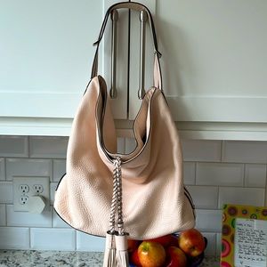 Pink shoulder bag with tassels.